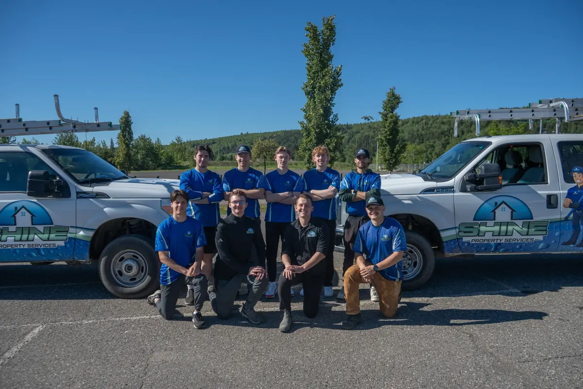 Shine Property Services team with branded service trucks